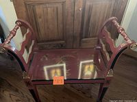 Full view of red painted bench showing arms, legs and seat