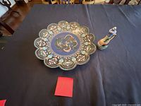 Front view of cloisonné plate and ceramic ewer