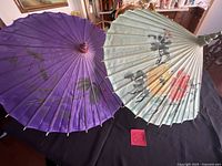 Top view of both parasols showing colors and painted designs