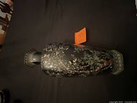 Top view of black Asian-style vase showing painted scene and hexagonal mouth