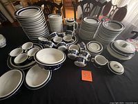 overview of complete dinnerware set stacked on table
