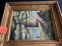 Front view of framed painting showing lighthouse scene and ornate frame