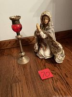 Front view of Mary statue beside lamp