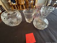 Group shot of four vases on table with lot number card