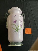 Reverse view with floral motif and handles