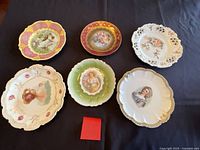 All six assorted porcelain plates on black background