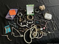 Overview of entire jewellery lot displayed on black surface