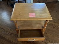 Top view of wooden end table showing surface and open drawer