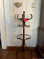 Full view of brown wood coat rack against wall