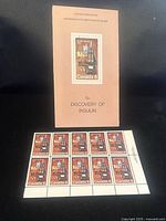 Front view of stamp block with pamphlet showing stamp design and text