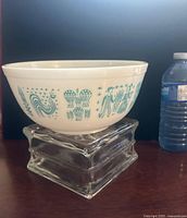 Side view of Pyrex Butterprint bowl on glass riser