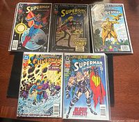 Five bagged comics laid out, fronts visible