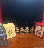 Boxes and four Grinch ornaments displayed