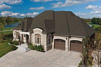Marketing image showing Cambridge WeatherWood shingle colour on a house roof