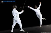 Two fencers in action demonstrating fencing stance and gear