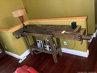 Full view of antique wooden workbench against wall