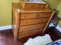 Front view of solid wood dresser showing 7 drawers and knob pulls