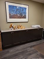 Front view of entire credenza beneath framed artwork