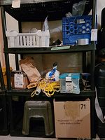 Overall view of three shelves containing hardware supplies