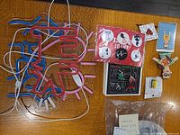 All items laid out: LED heart light, buttons pack, enamel pin set, single pin, journals bag, puppet, sticker