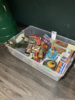 Overall view of bin showing variety of loose and boxed wind-up toys