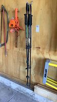 Four McKinley trekking poles hanging, full length view