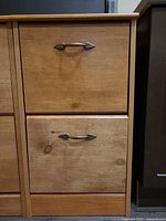 Front view showing two drawers, wood finish, metal pulls