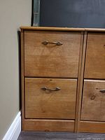 Front view left portion showing two drawers and metal pulls