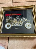 Framed Tymeart clock art showing full vehicle design and frame