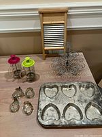 All items laid out: two French presses, heart muffin pan, cupcake stand, washboard, cookie cutters