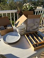 Boxed Royal Doulton ED dishes, stack of plates, bowls and cutlery tray on table