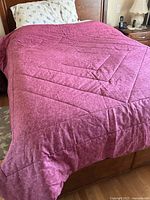 Duvet spread on bed showing full surface and colour