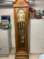 Full view of Ridgeway grandfather clock showing wooden case and glass door