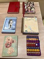 All six journals front covers displayed on table