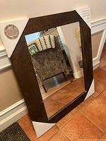 Full view of mirror with wood frame and corner protectors