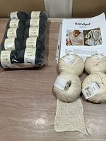 Pack of ten Rowan Softyak DK balls with pattern and silk yarn visible