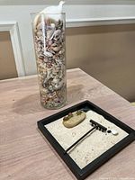 Overall lot showing vase of shells and zen garden tray