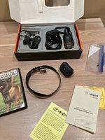 full set in open box with transmitter, collar, charger; manual, DVD, extra receiver, yellow sheet