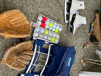 Overall lot showing skates, gloves, golf balls, backpack
