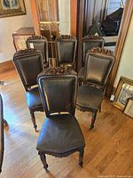 Six matching carved wood side chairs, grouped