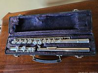 Flute body and footjoint in case showing closed-hole keys