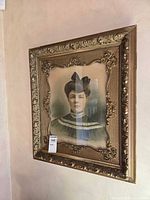 Full view of framed portrait hanging on wall