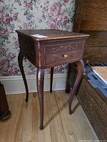 Full view of sewing table showing inlaid top and cabriole legs