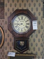 Front view of Bulova octagon drop schoolhouse wall clock on wall