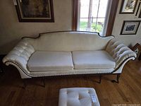 Full front view of cream camelback sofa