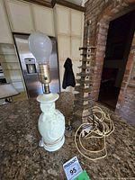 Ceramic lamp and brass pagoda lamp base side by side on countertop