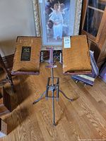 Full view of adjustable oak and iron book stand on tripod base