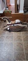 Full side view of rocking horse on tiled floor