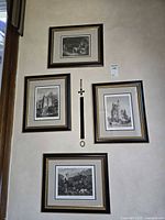 Full view of four framed prints hanging on wall