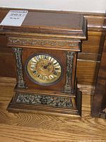 Front view of clock showing full case and dial